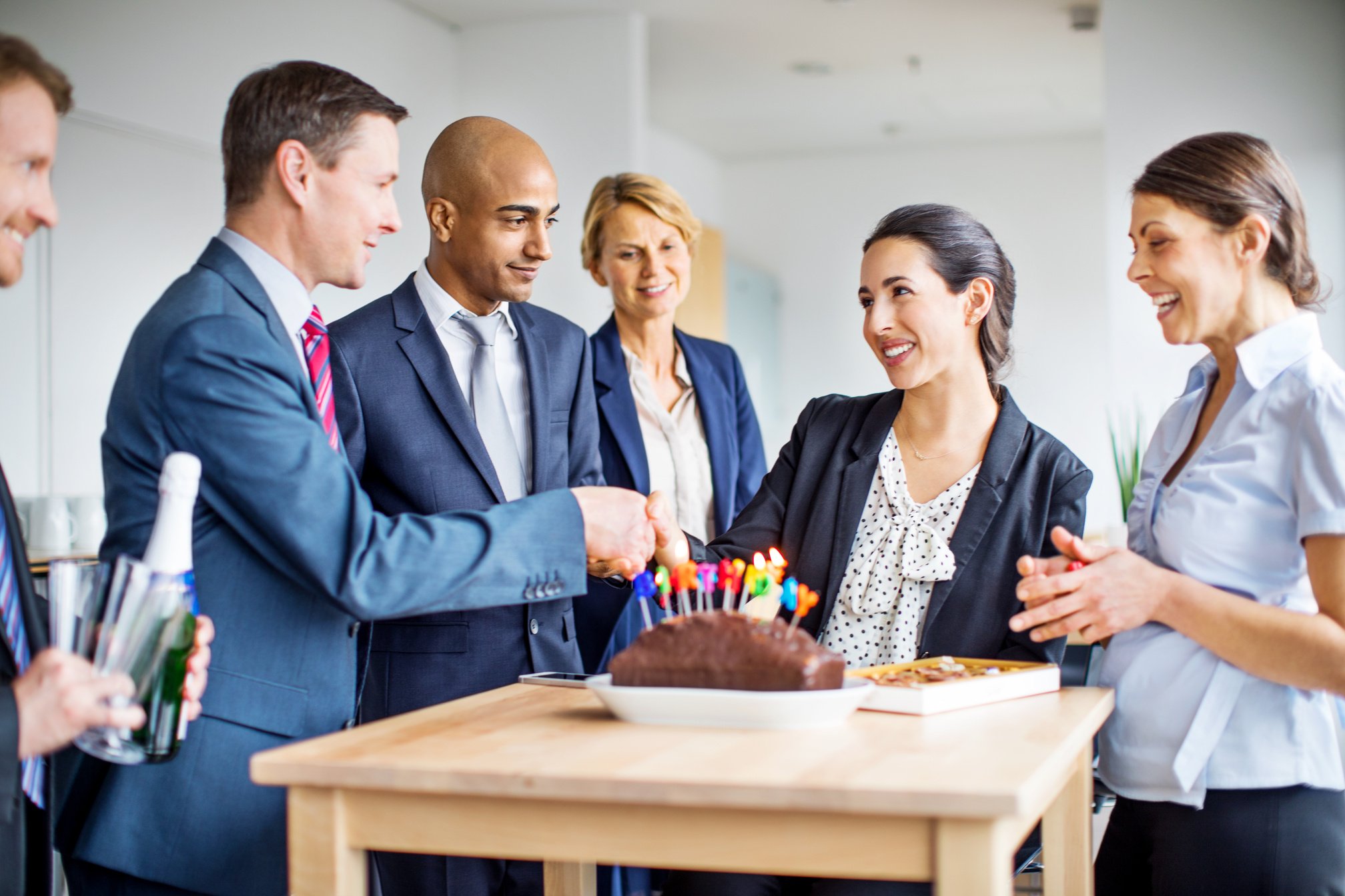 Corporate workers celebrating female colleague's birthday